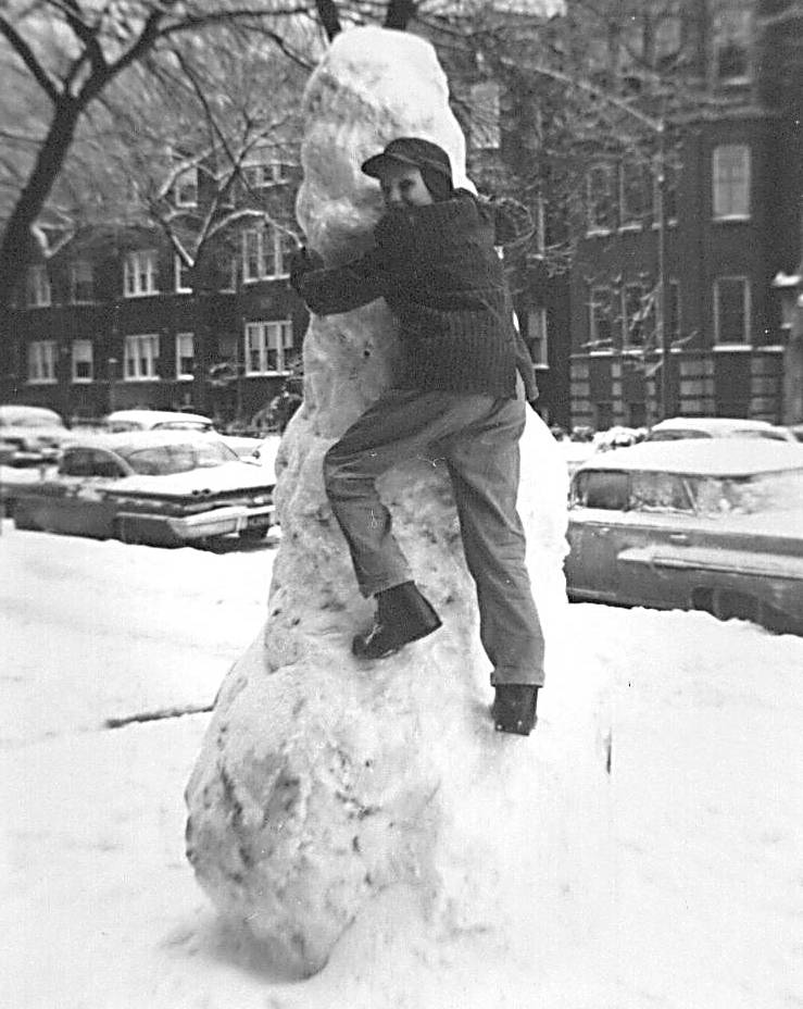 BILL CHUCKMAN GIVING ONE OF OUR SNOWMEN A LAST TOUCH - ESSEX AVE SOUTH NEAR THE RAIL TRACKS - FRONT YARD OF SOMEONE ELSE'S BUILDING - THAT WAS OUR URBAN VILLAGE - A JOHN CHUCKMAN PHOTO