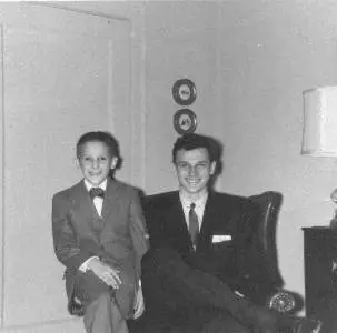 JOHN AND BILL CHUCKMAN - IN AUNT WILMA'S SMALL, ELEGANT PHILLIPS AVE APARTMENT THE DOORS BEHIND ARE THE HID-A-BED - A CHUCKMAN FAMILY PHOTO